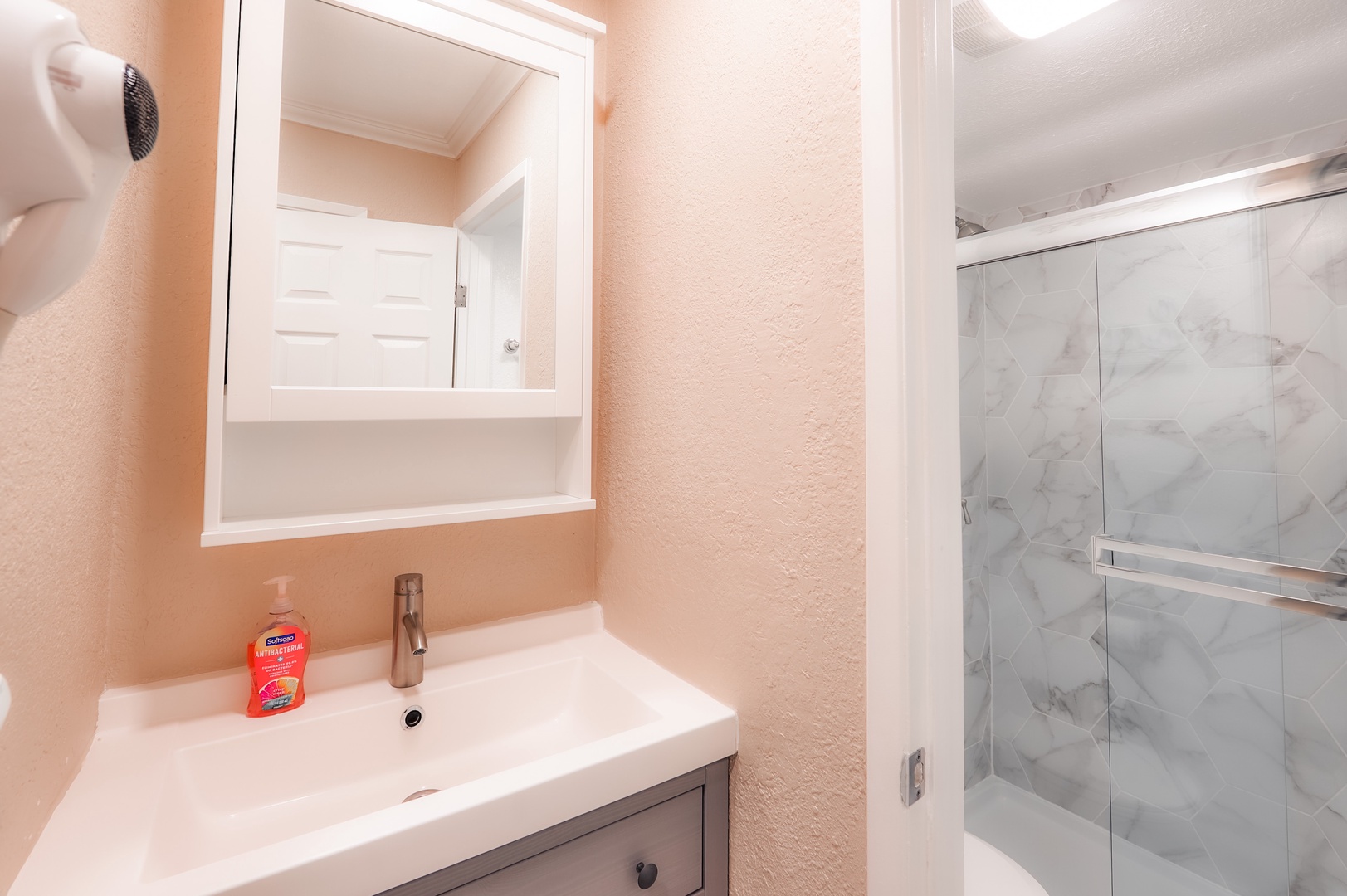 The shared full bathroom includes a single vanity & shower