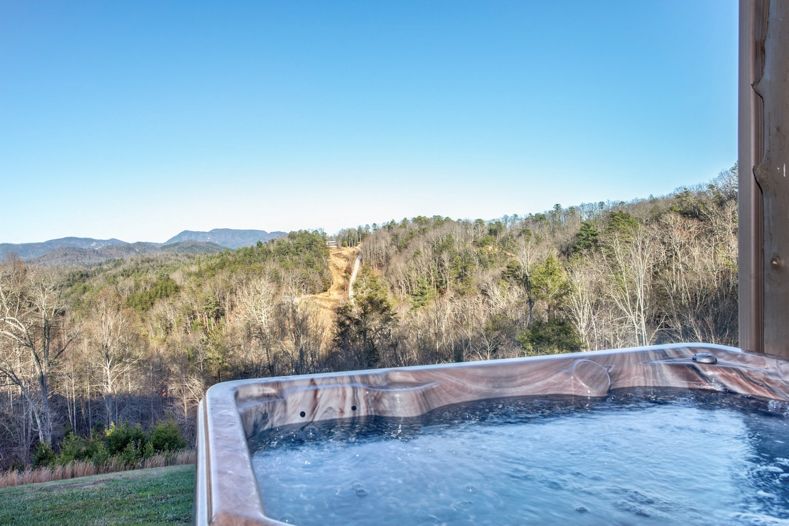 Relax in the private hot tub, soaking in the views throughout the day