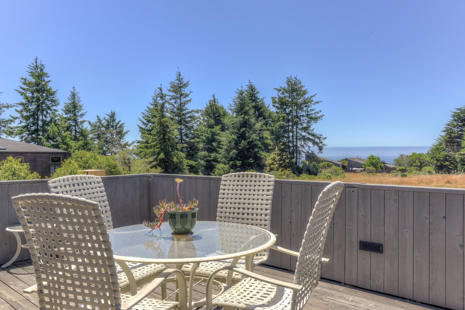 Ocean view deck with BBQ, hot tub, and seating