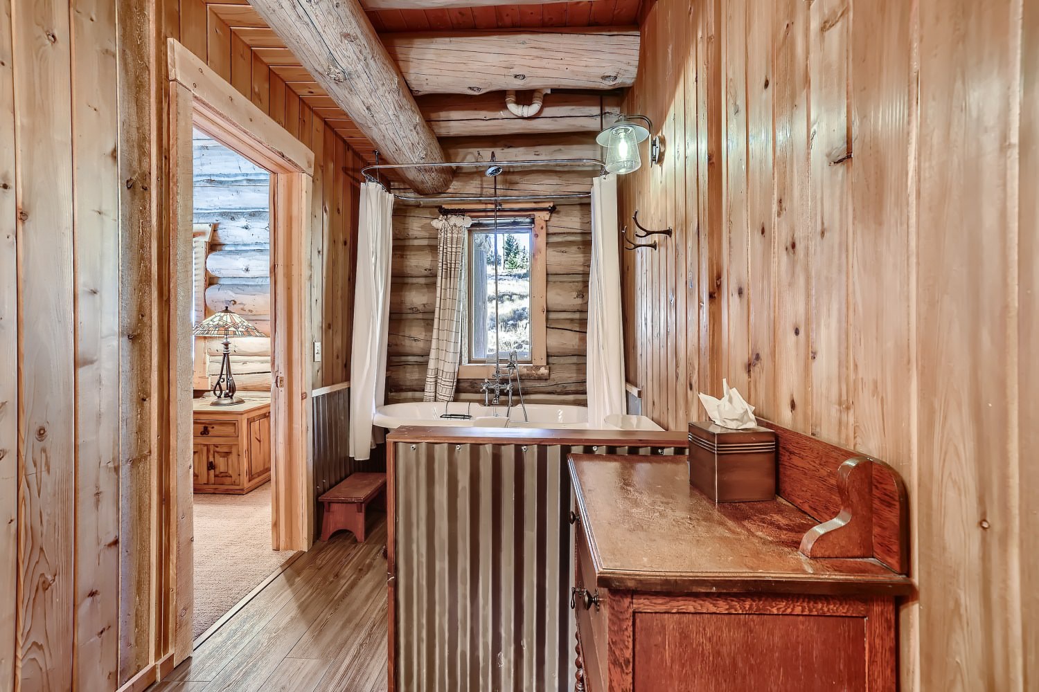 Shared bathroom on the main floor with claw foot tub, and shower combo