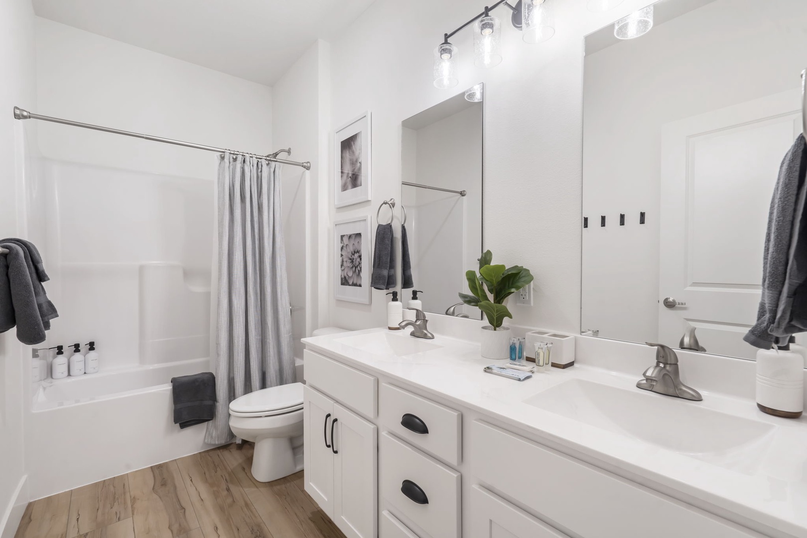 Enjoy a wide double vanity and shower/tub combo in the shared bathroom