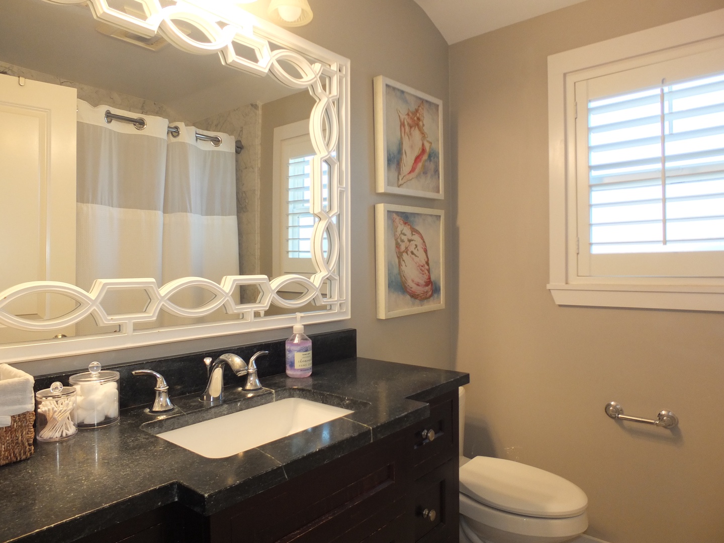 This full bathroom provides a single vanity & shower/tub combo