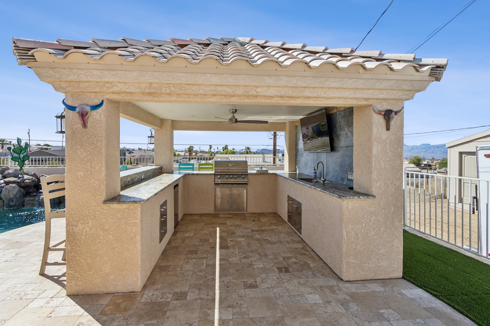 A mountain-view oasis, with a waterfall pool, hot tub, & outdoor kitchen!