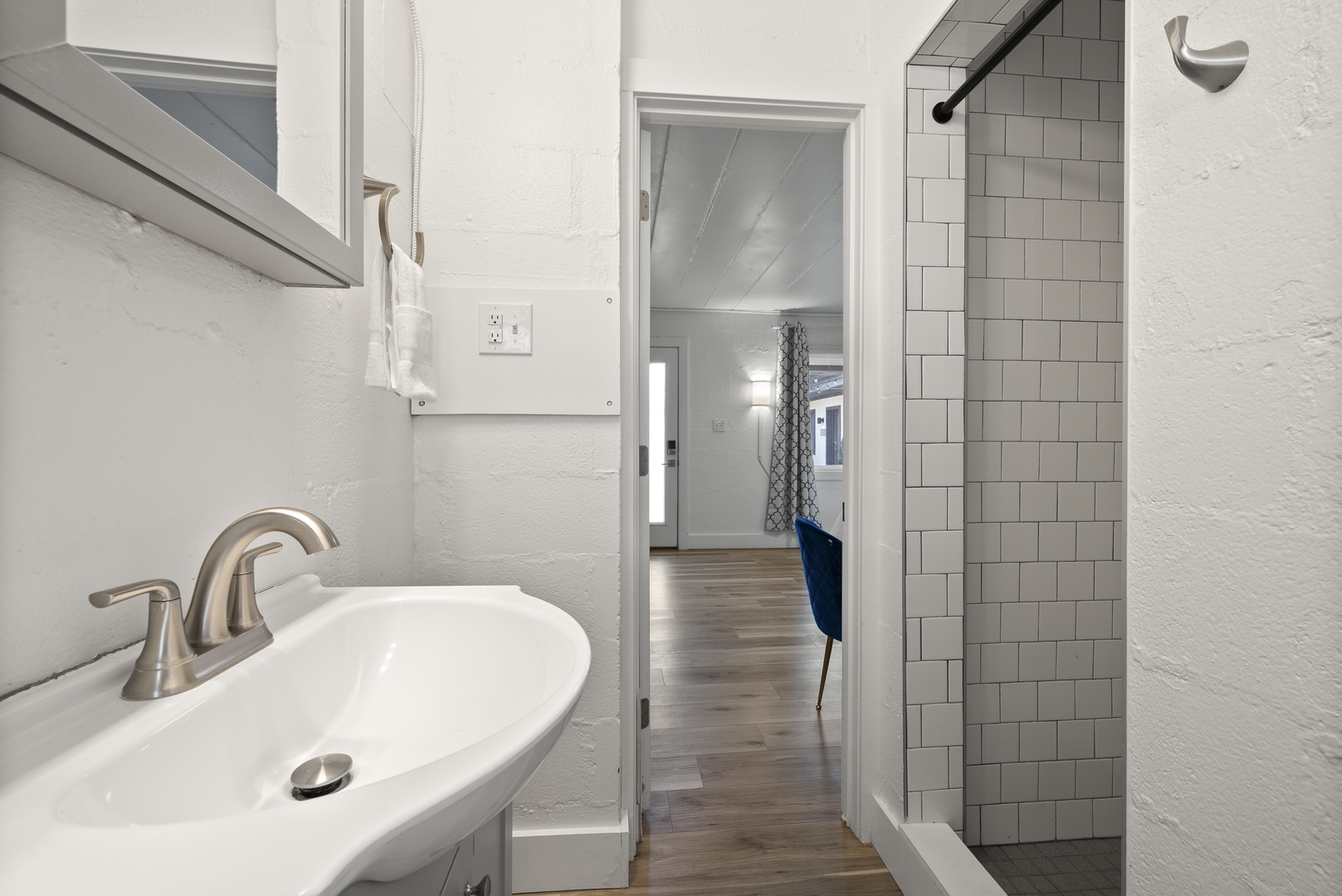 Refresh in the full bath, featuring a single vanity & tiled shower