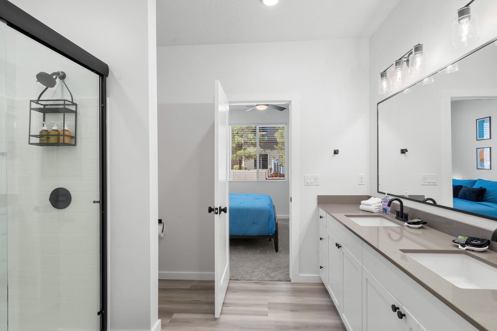 The first bedroom’s ensuite features a dual vanity, shower, & walk-in closet