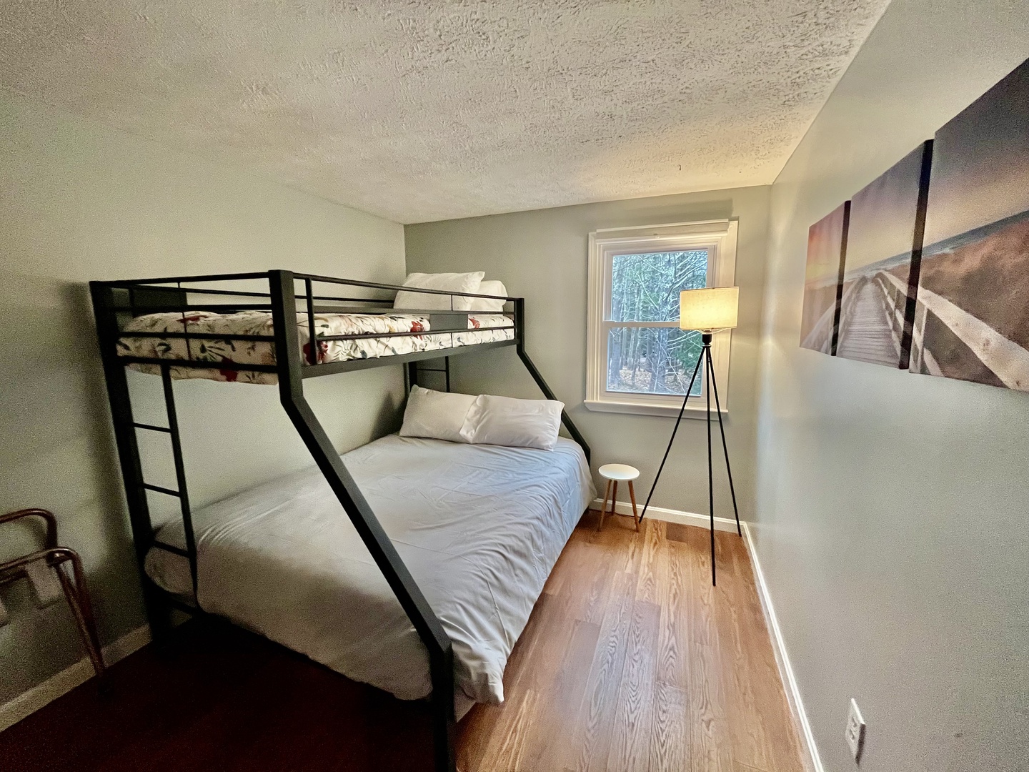 This bedroom retreat offers twin over queen bunkbed and cozy reading area