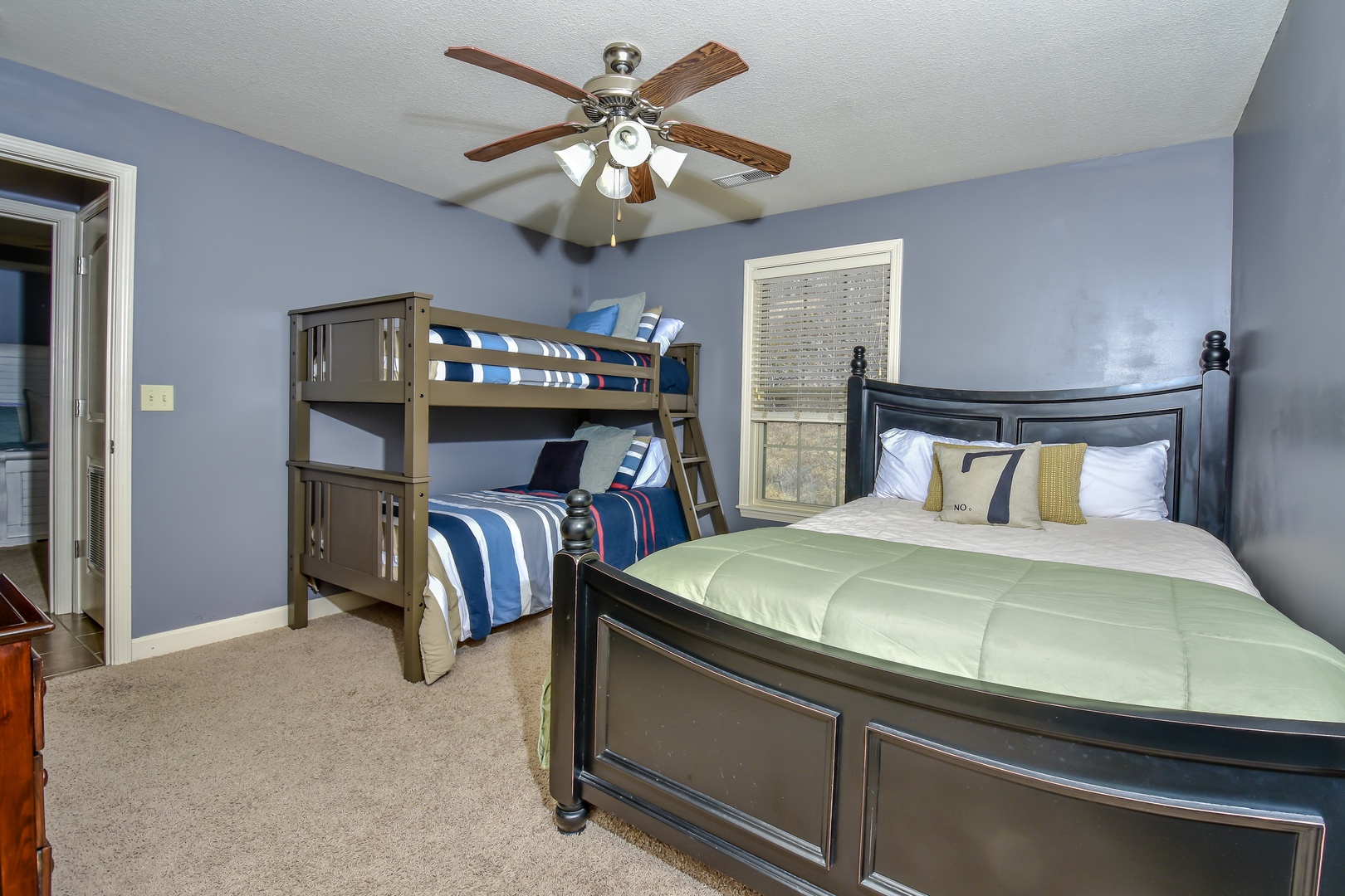 Full-over-full bunks, a queen bed, & Smart TV await in the second bedroom