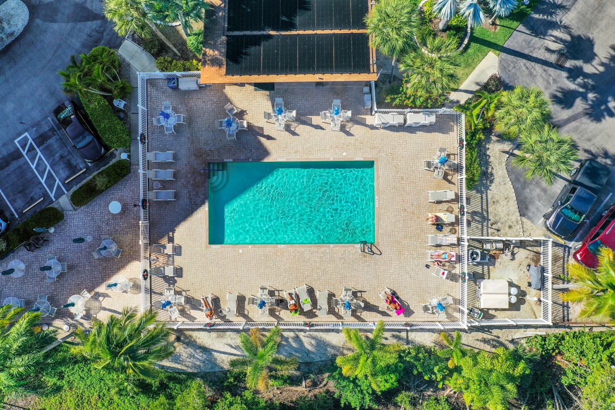 Aerial view of complex with pool