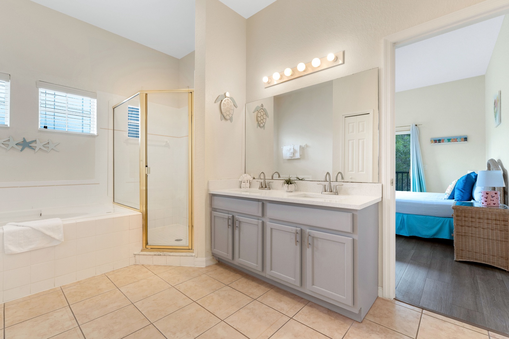 This ensuite with double vanity, shower, & tub also attaches to the hall