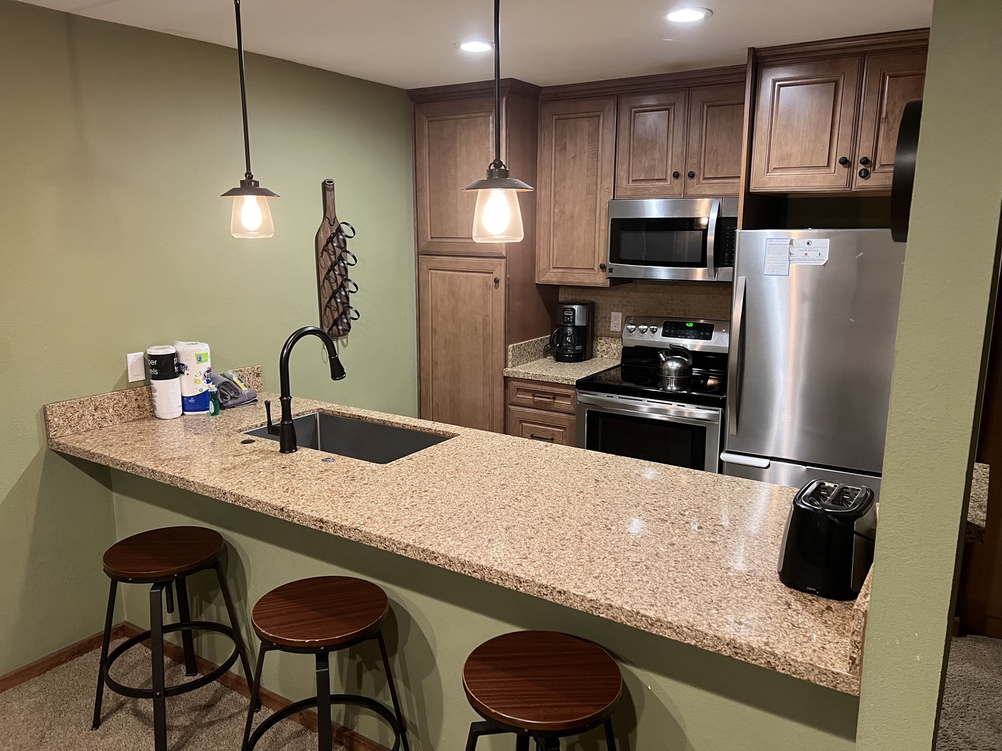 Newly remodeled kitchen with new appliances, breakfast bar for 3