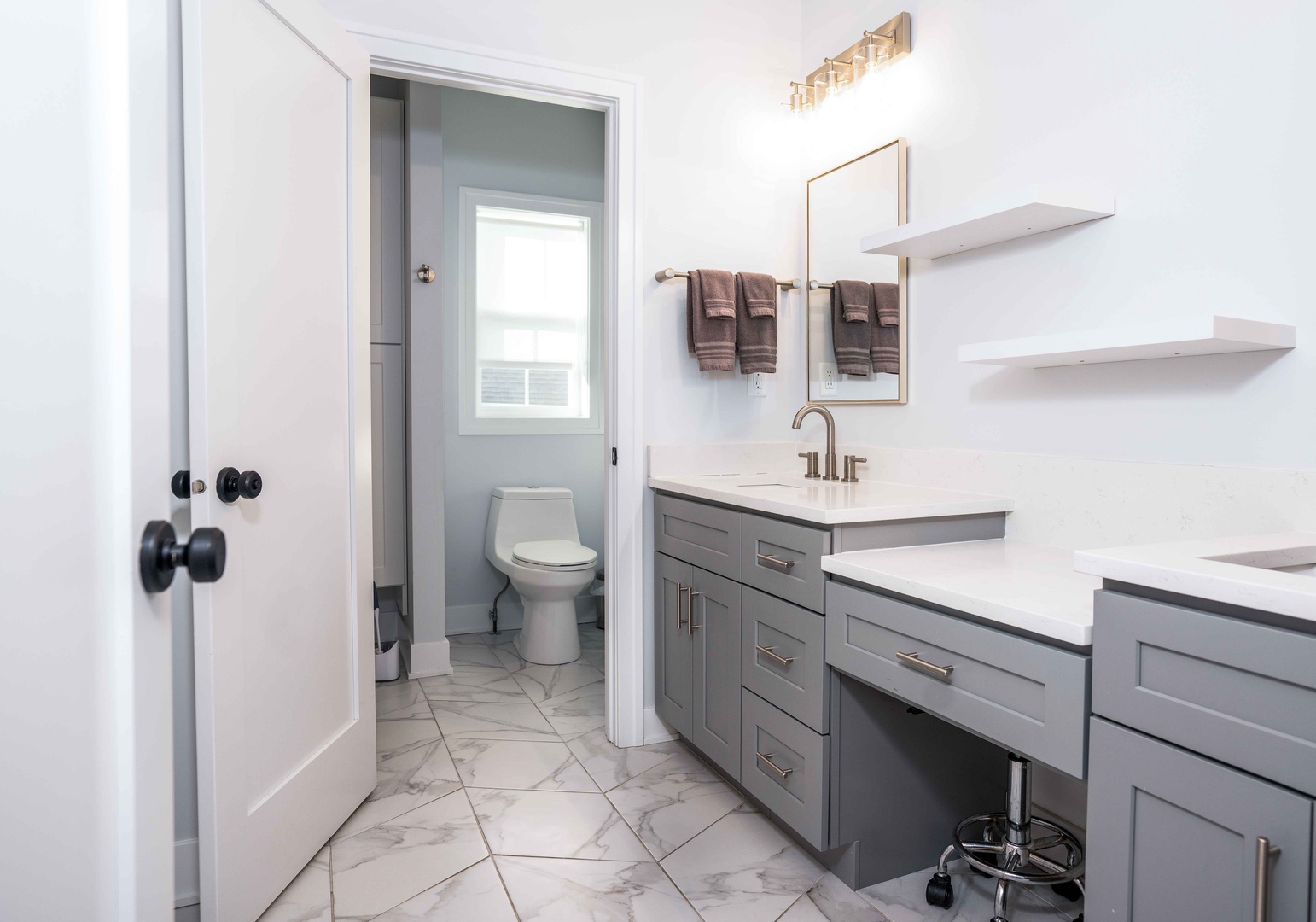 This private ensuite features a double vanity, makeup counter, & shower