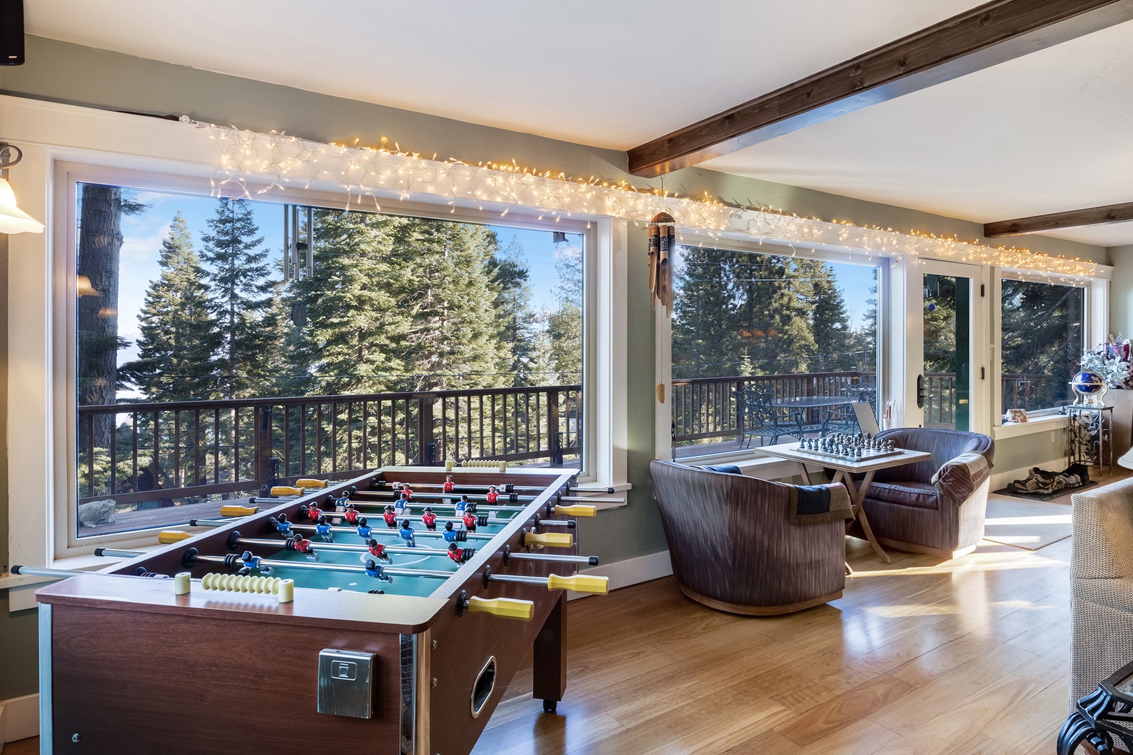 Mountain style living room with fireplace, smart TV and games