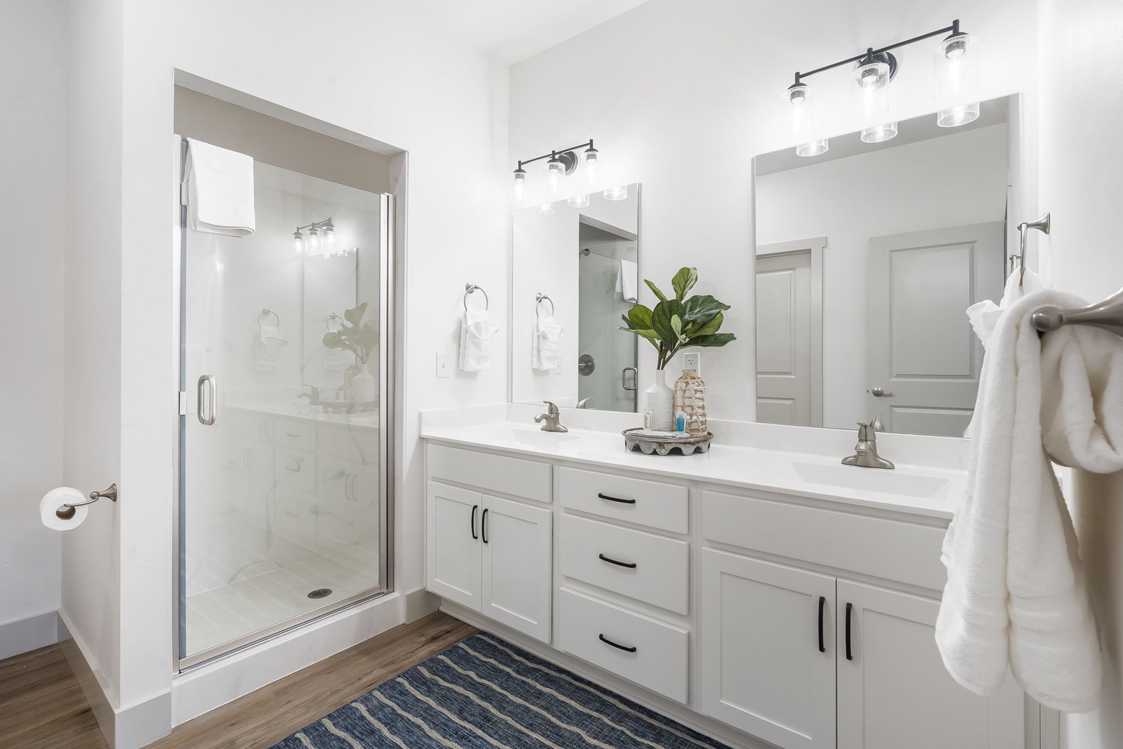 Find a spacious double vanity and spa-like glass shower in the king en suite