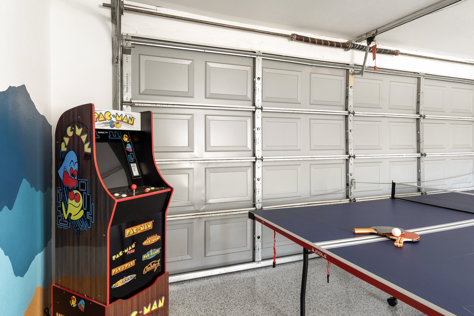 Game room with seating area, ping pong table, board games, and PacMan game