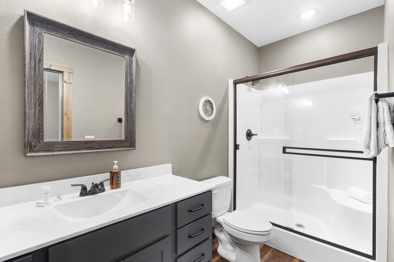 The fourth bedroom’s ensuite features a single vanity & shower/tub combo