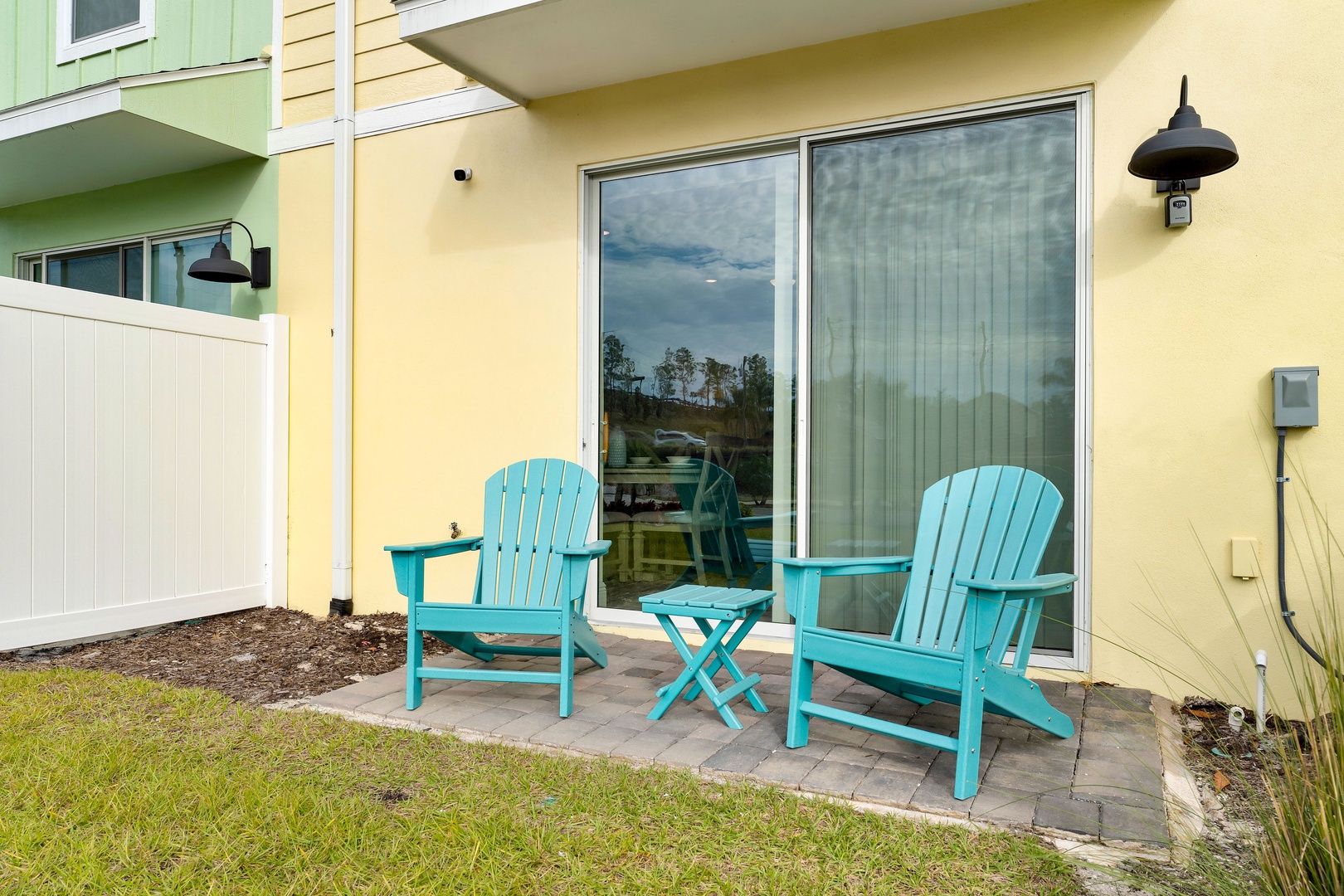 A pair of Adirondack chairs with a charming side table, ready for relaxation on the patio