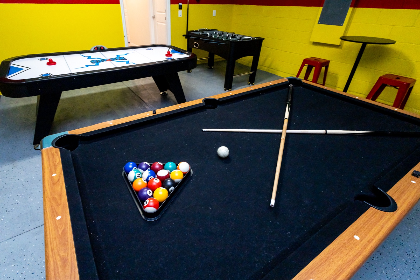 Get competitive in the garage game room with pool, air hockey, & foosball