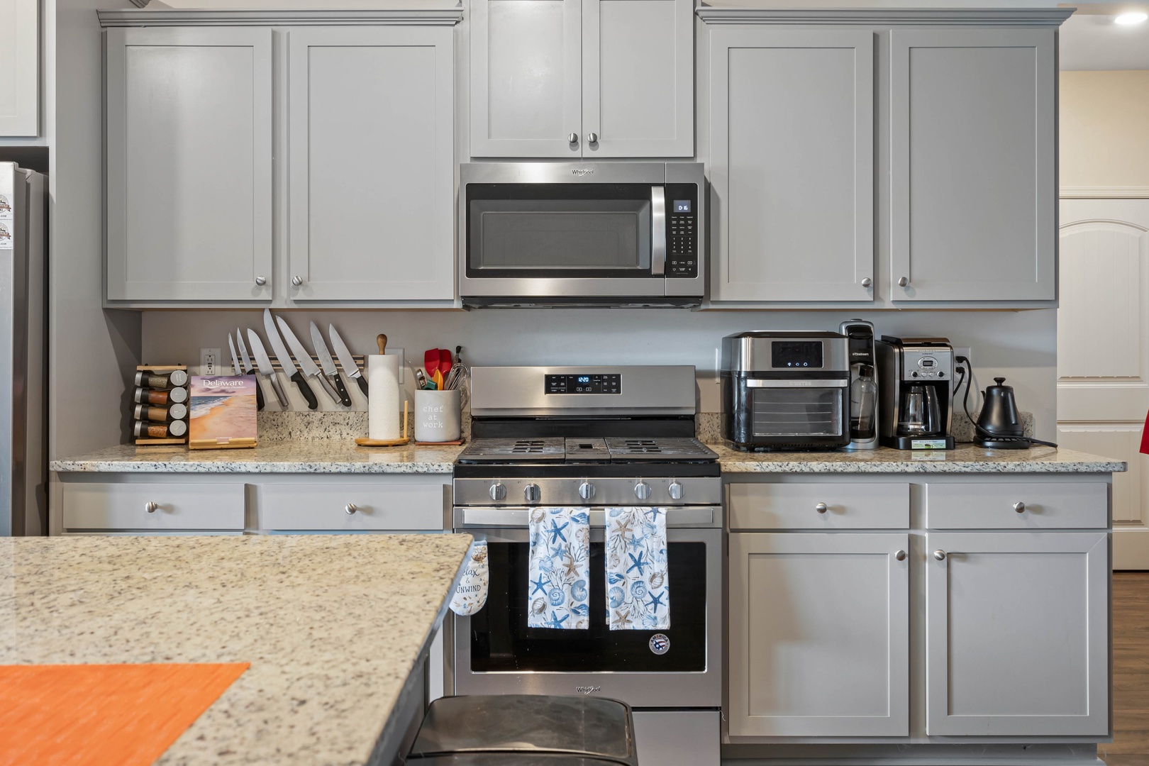 The chic, updated kitchen offers ample space & all the comforts of home