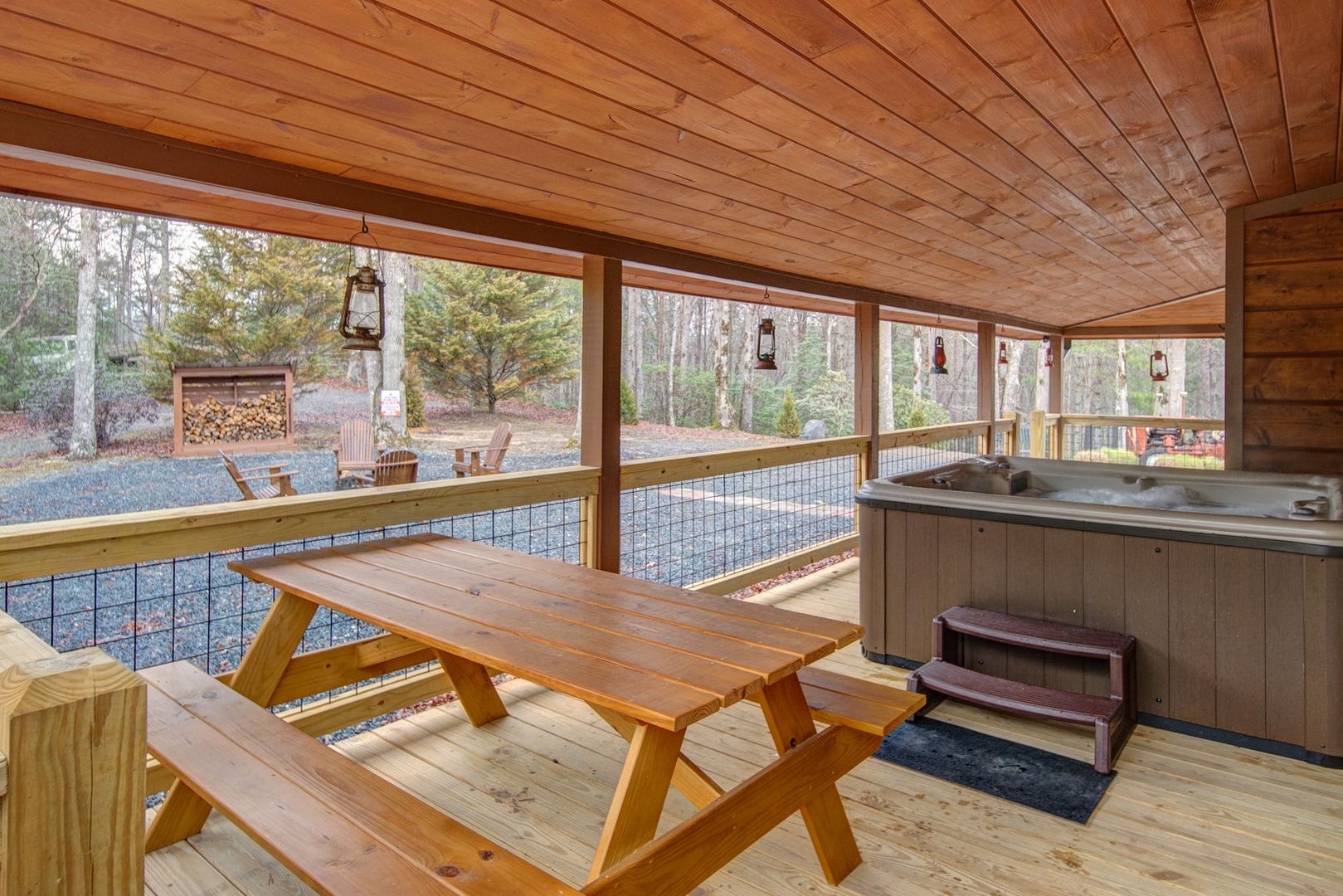 Hot Tub and picnic table on the covered wrap around porch