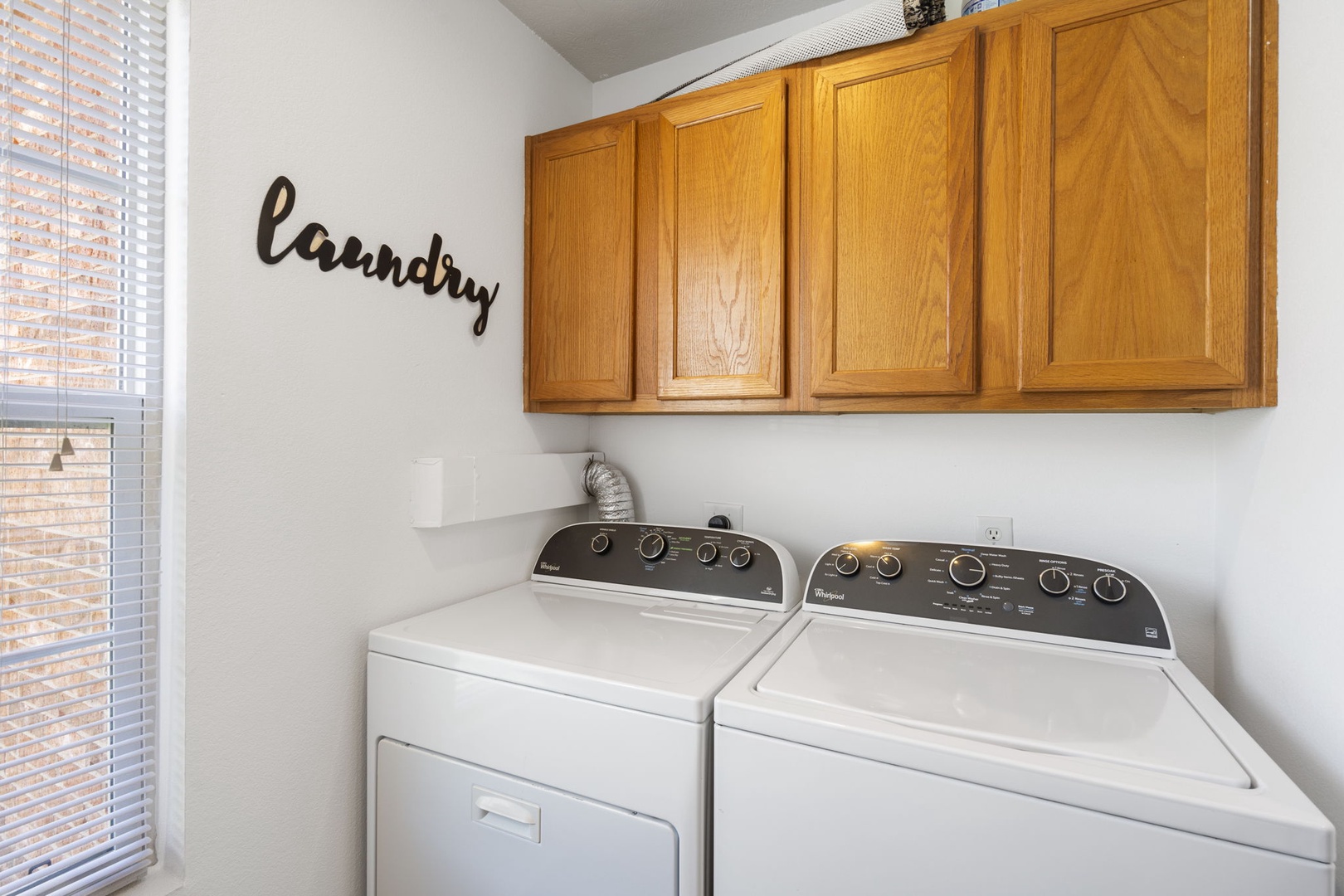 Enjoy access to private laundry during your stay, tucked away past the kitchen