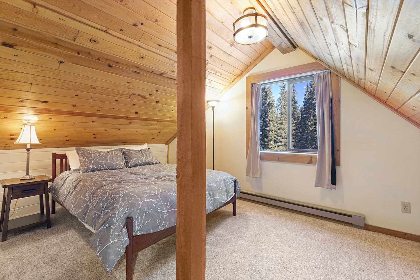 A plush queen bed & private ensuite await in this tranquil upper-level suite