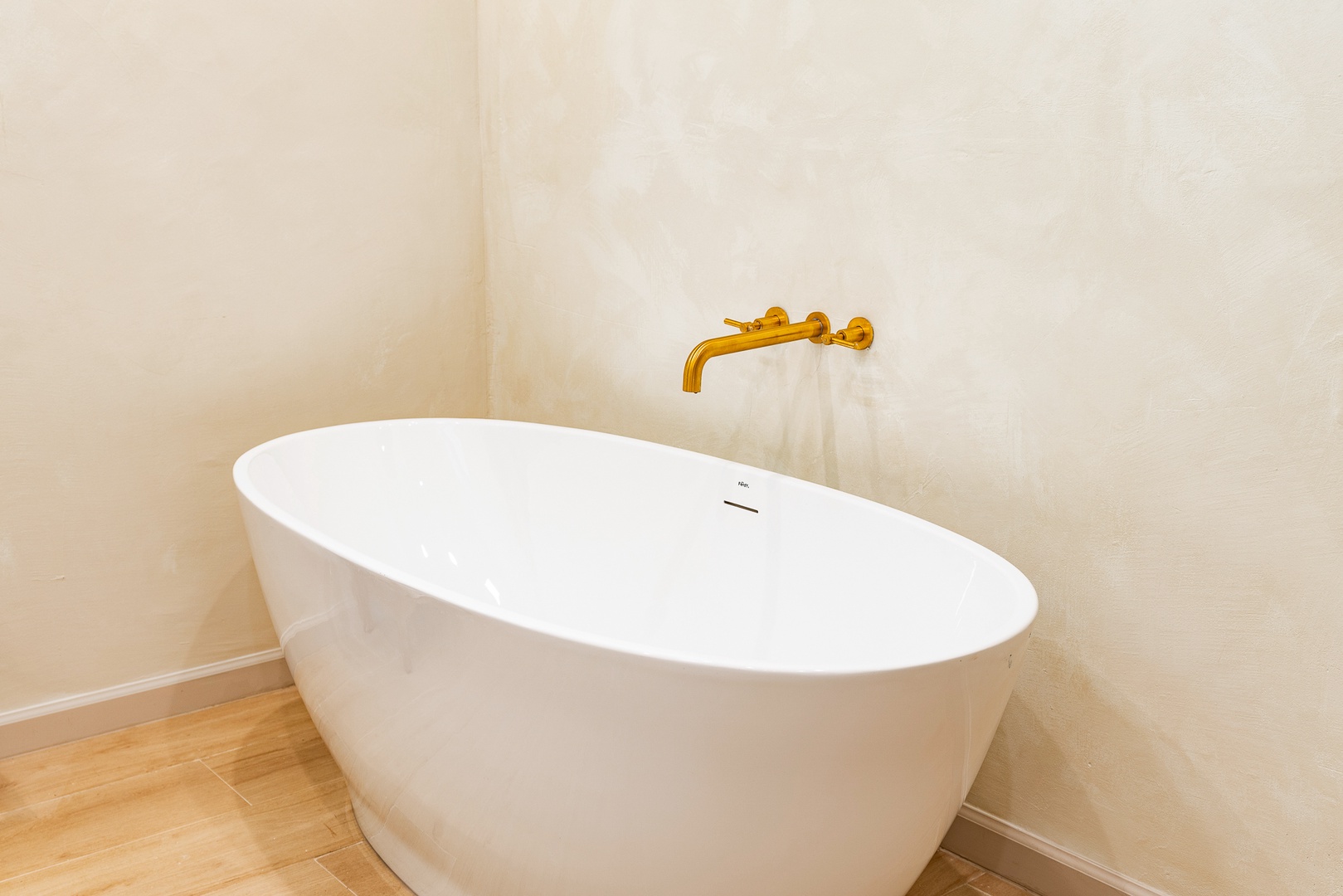 A chic vanity, shower, & luxurious soaking tub await in this ensuite bath