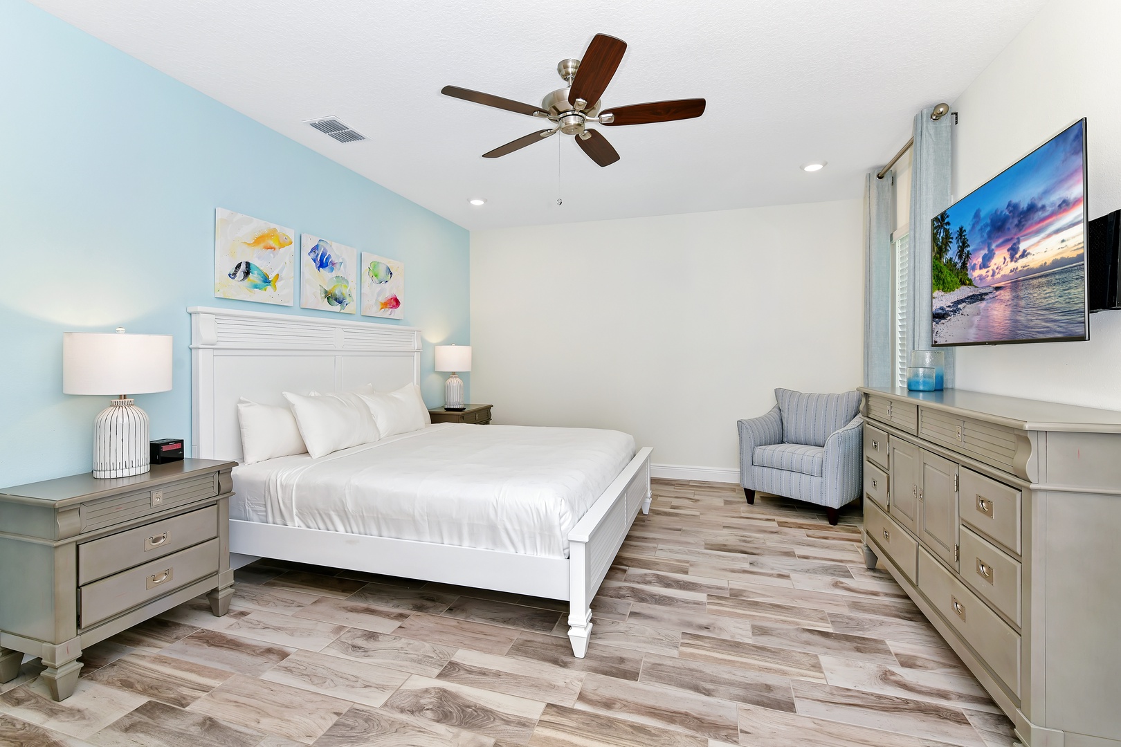 2nd Floor Master featuring a cozy king bed, ceiling fan and private ensuite