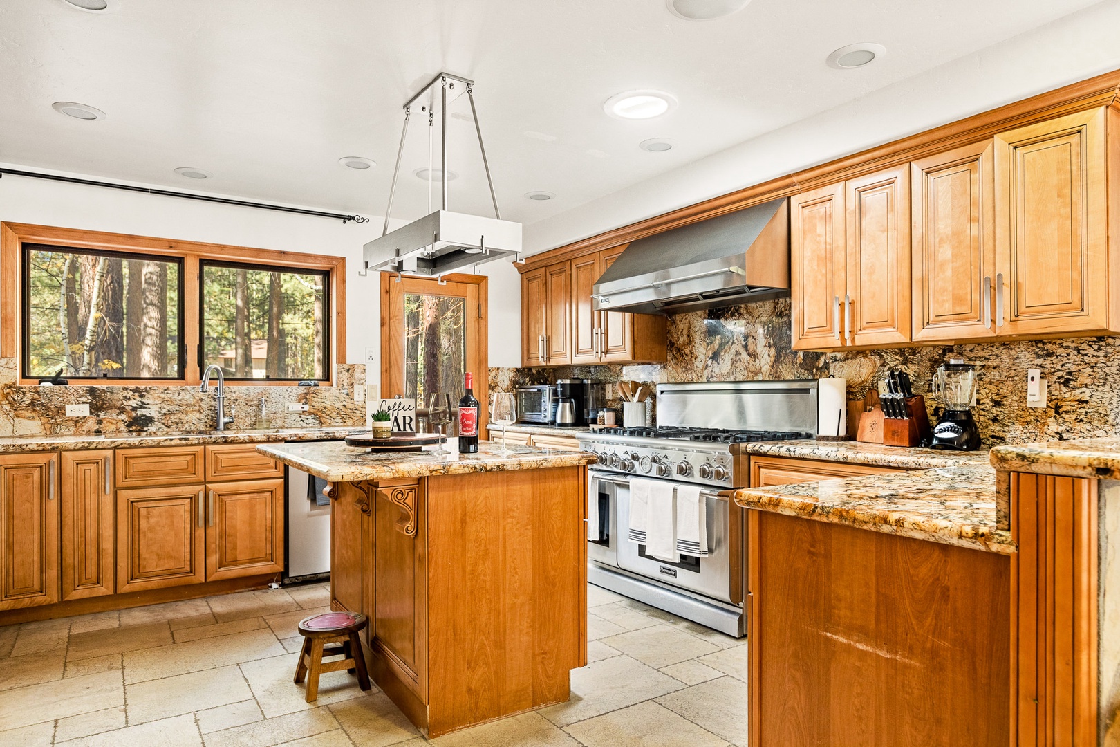 Spacious kitchen with large range grill, and stainless steel appliances