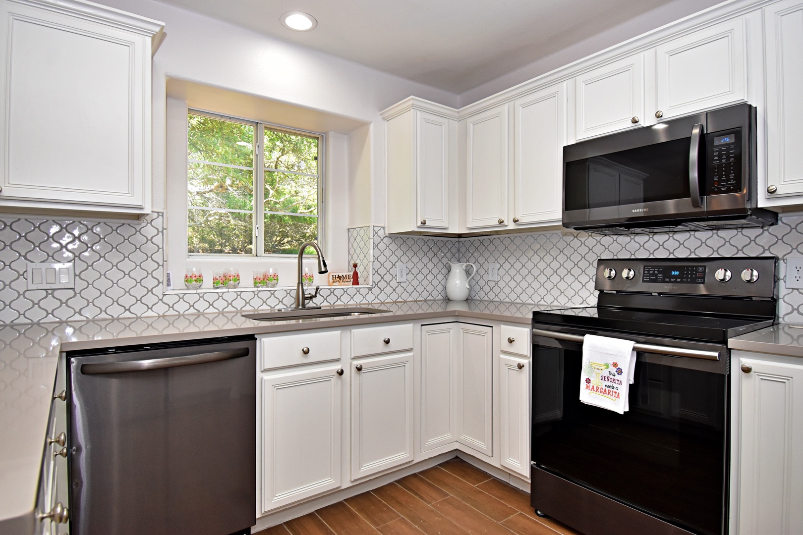 The chic kitchen offers ample space & all the comforts of home