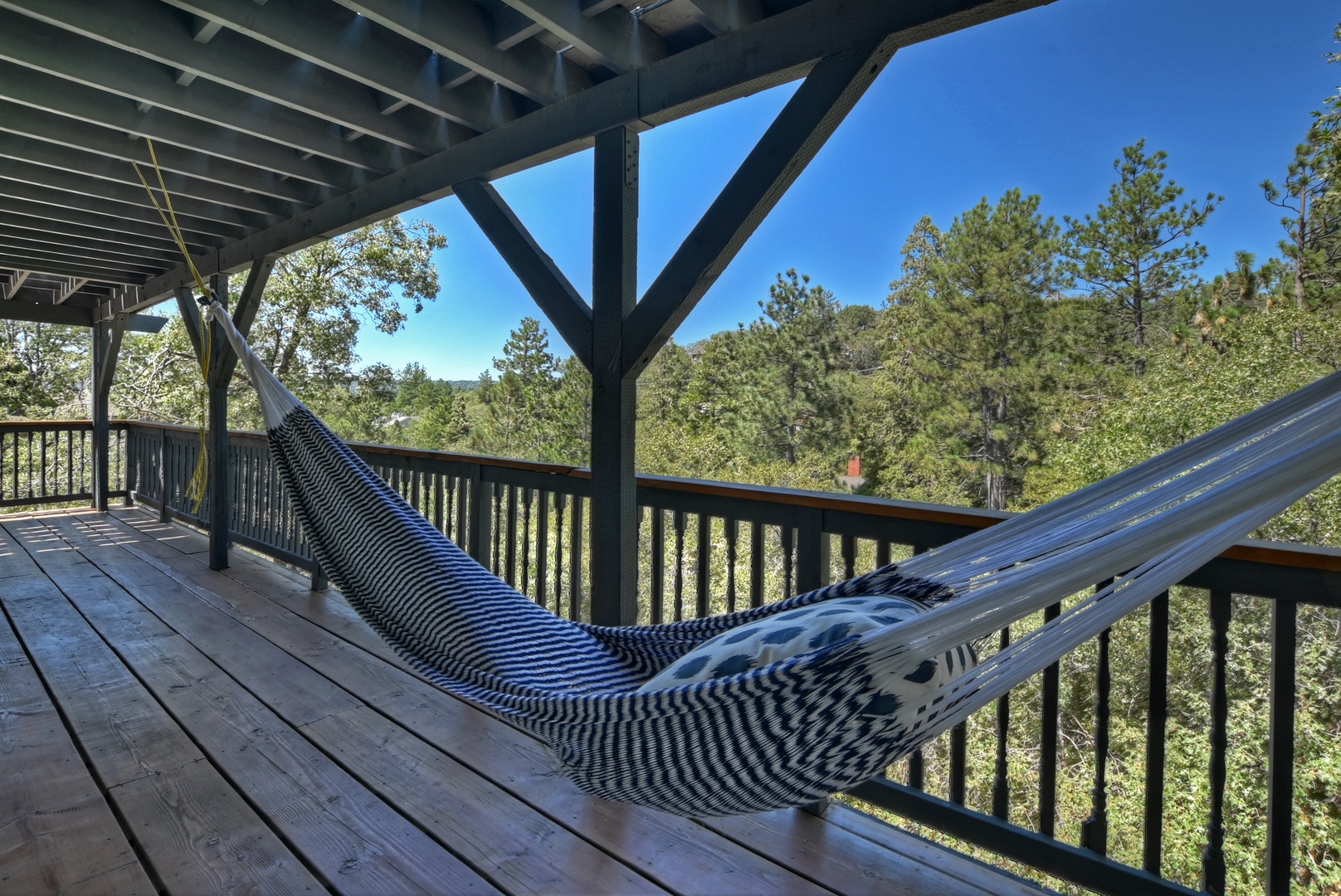 Deck with hot tub, seating, and hammock