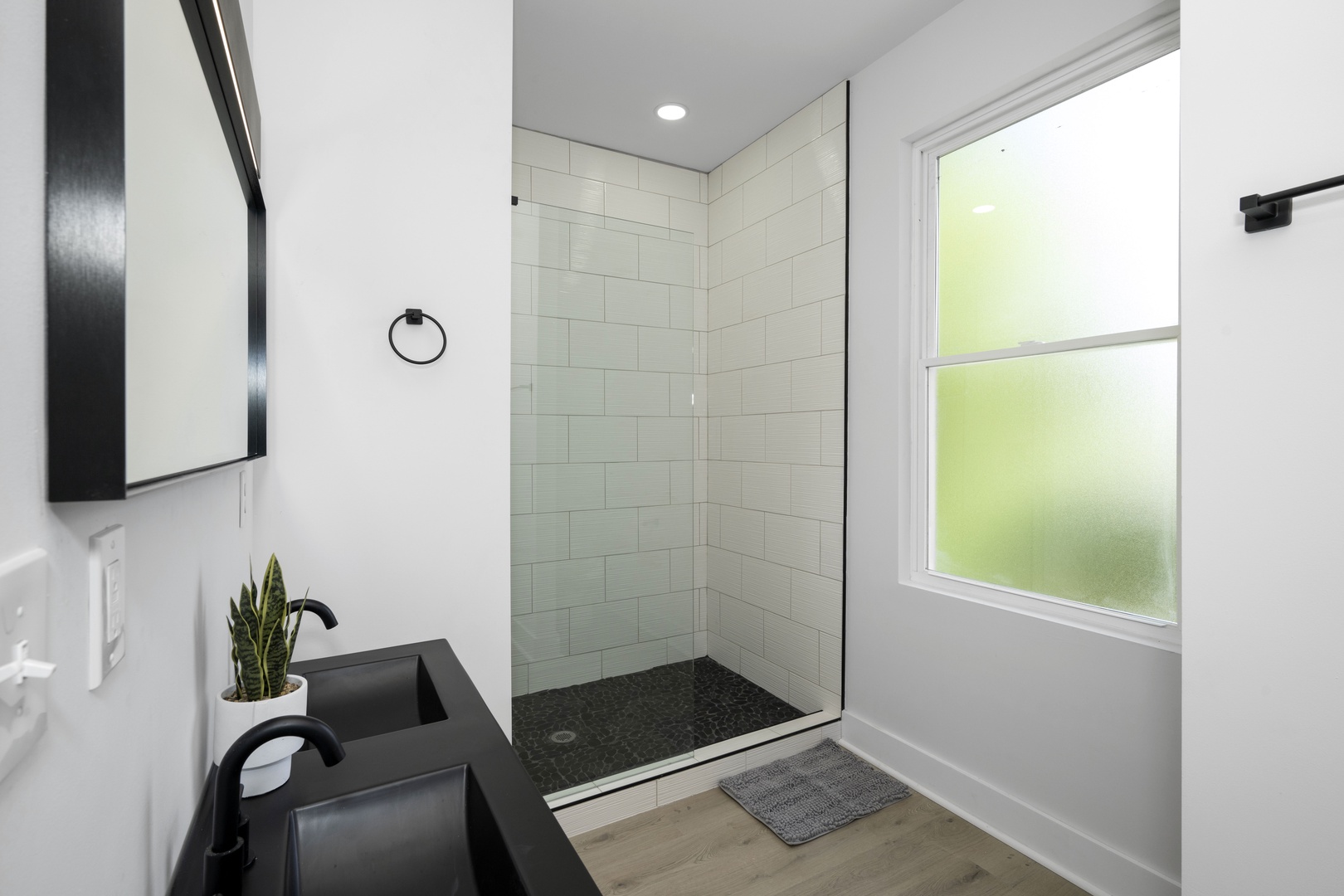 The king ensuite offers a sleek double vanity & luxurious glass shower