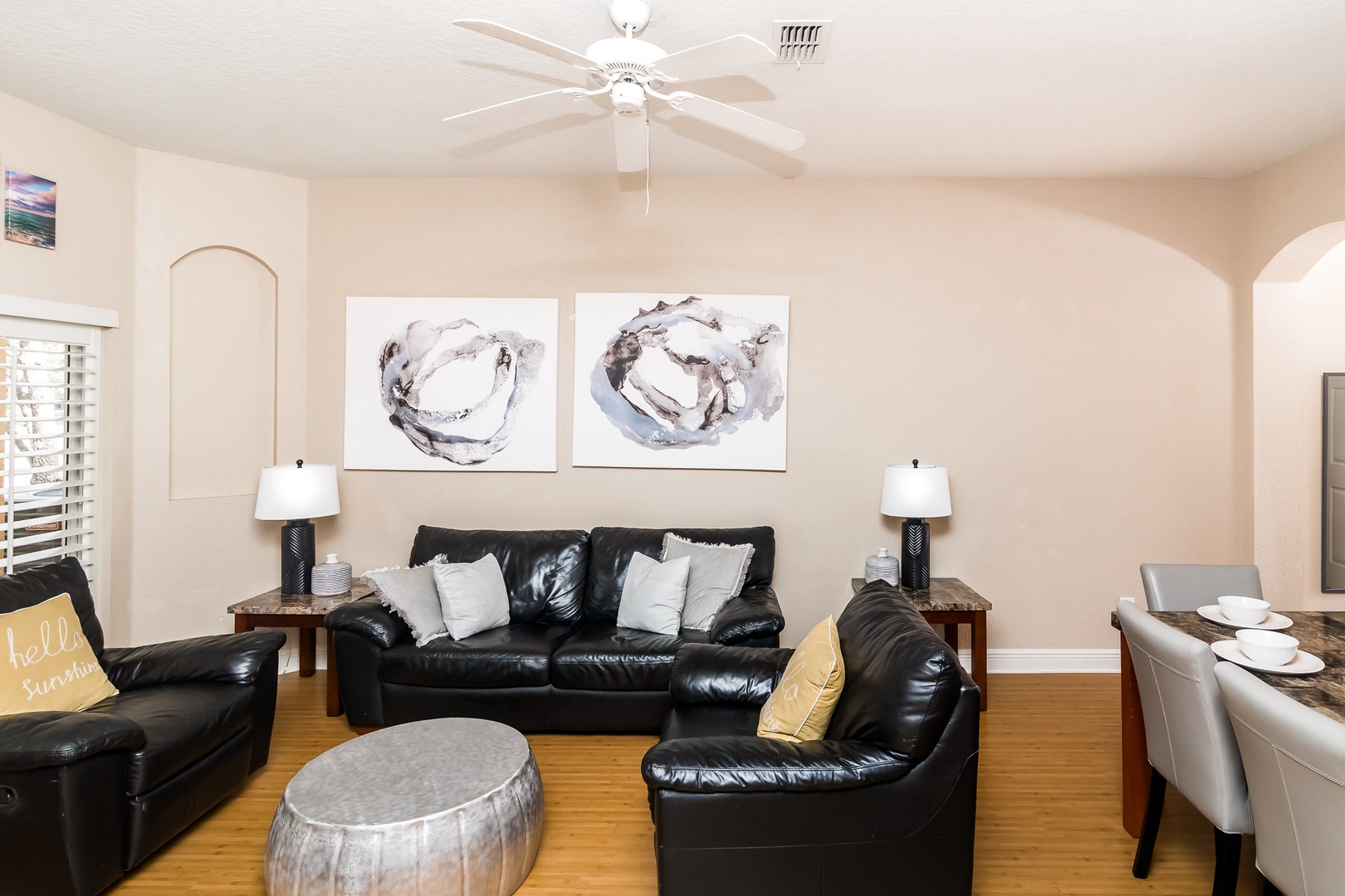 An open living space which features ample seating, cable TV, and access to the back patio