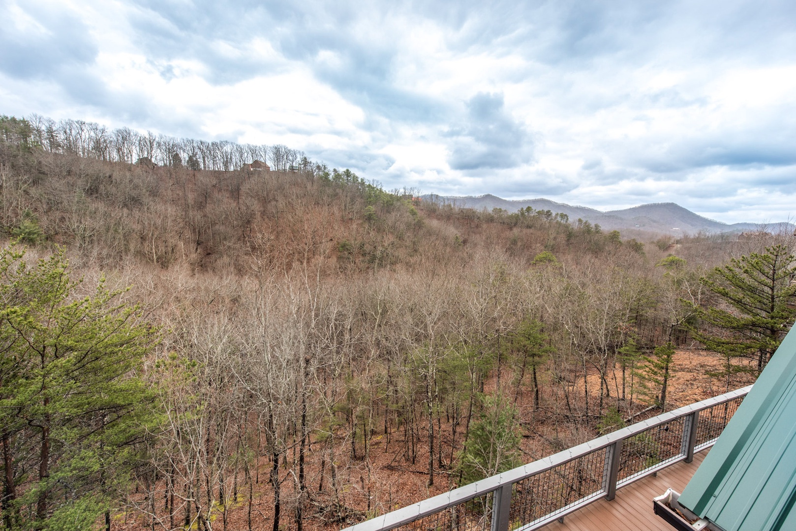 The private upper-level balconies offer breathtaking forest & mountain views