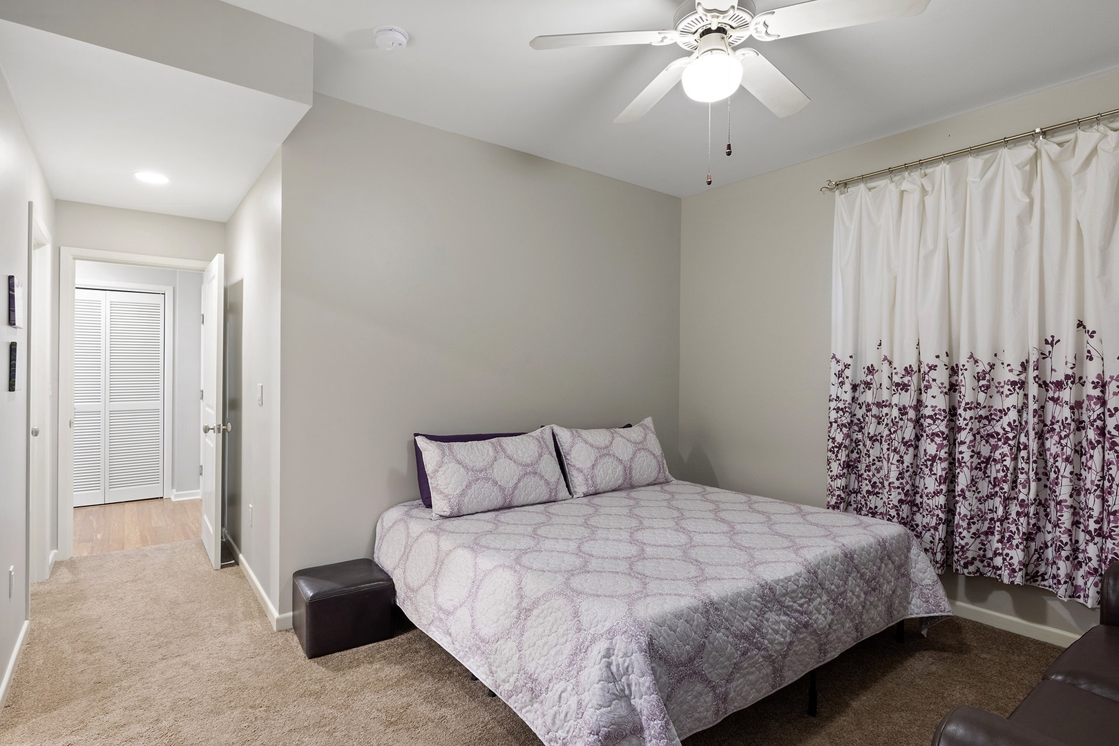 Bedroom 1 with King bed,  shared en-suite, and love seat (1st floor)