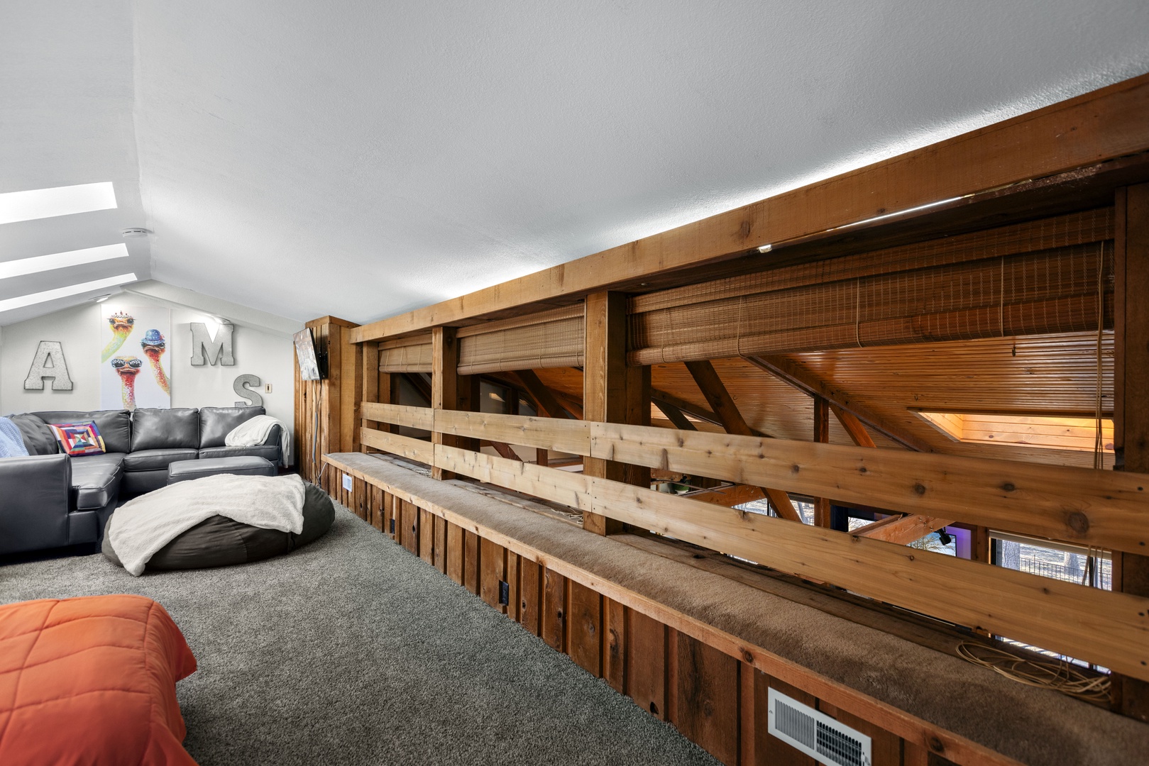 The loft features a pair of twin beds, cozy tv area, and convenient half bath
