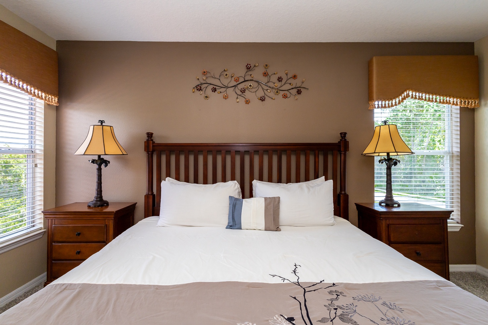 The king suite boasts a luxurious private en suite, TV, & ceiling fan