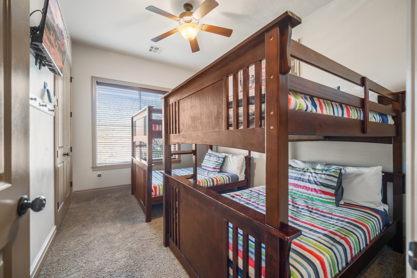 A pair of full-over-full bunkbeds & smart TV await in the final bedroom