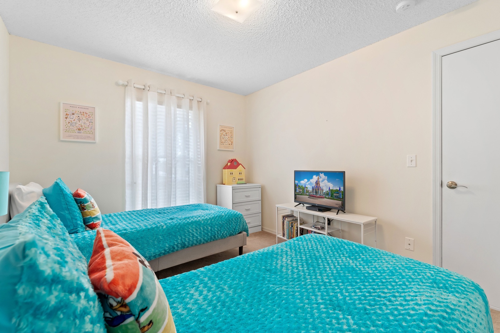 Two cozy twin beds await in the first bedroom retreat