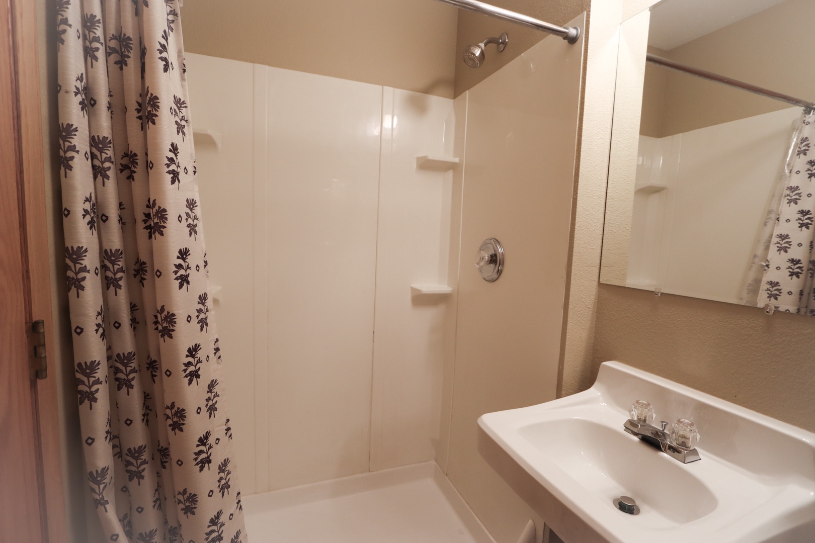 The queen en suite includes a single vanity & walk-in shower