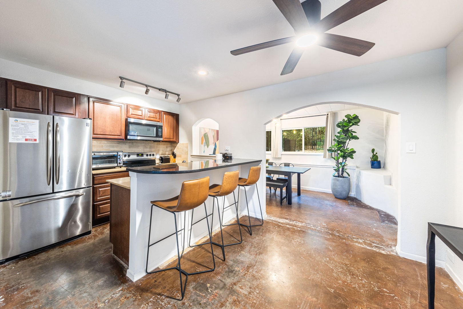 Kitchen with counter seating open to dining area