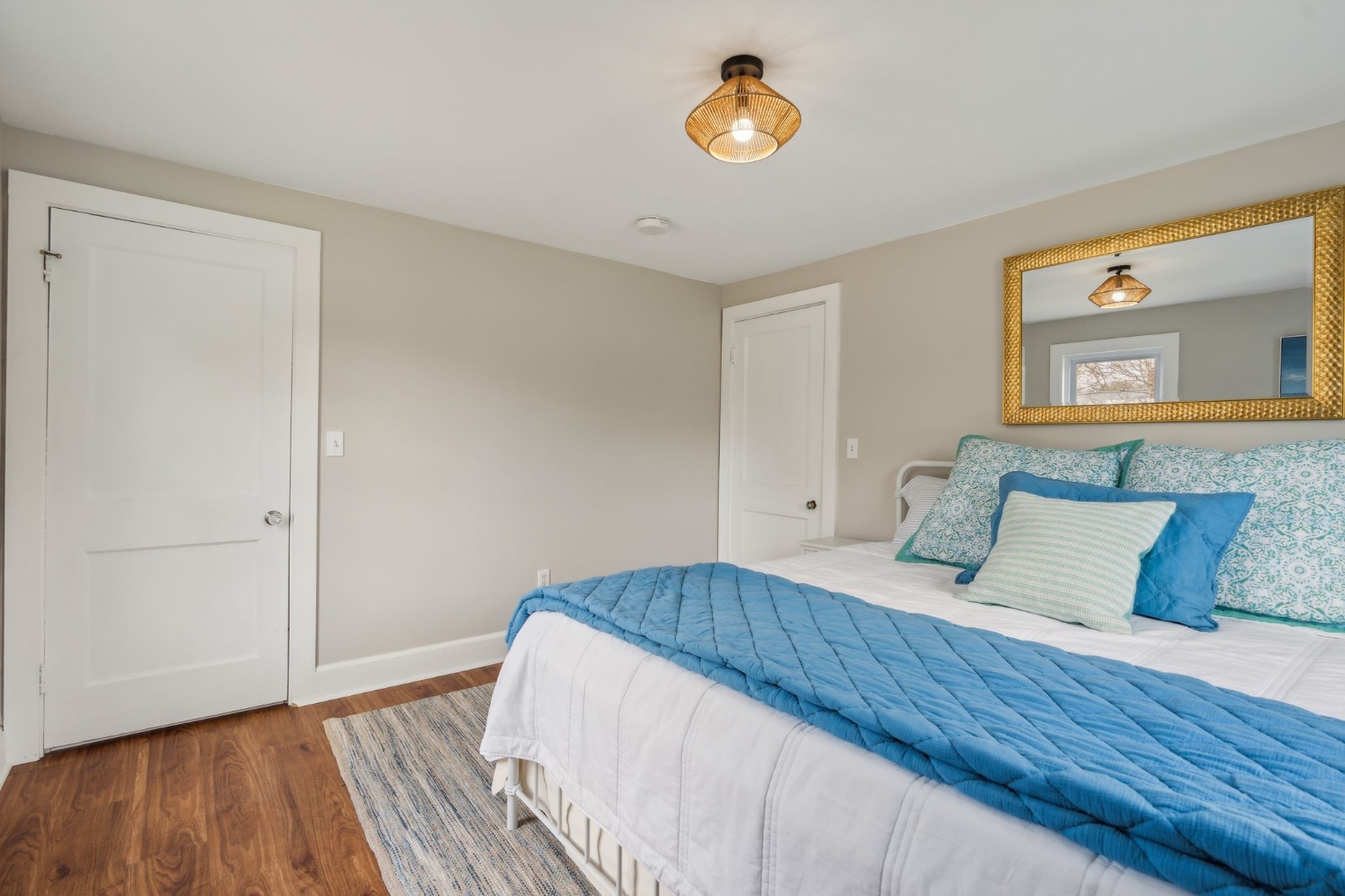 This airy bedroom features a luxurious king-size bed