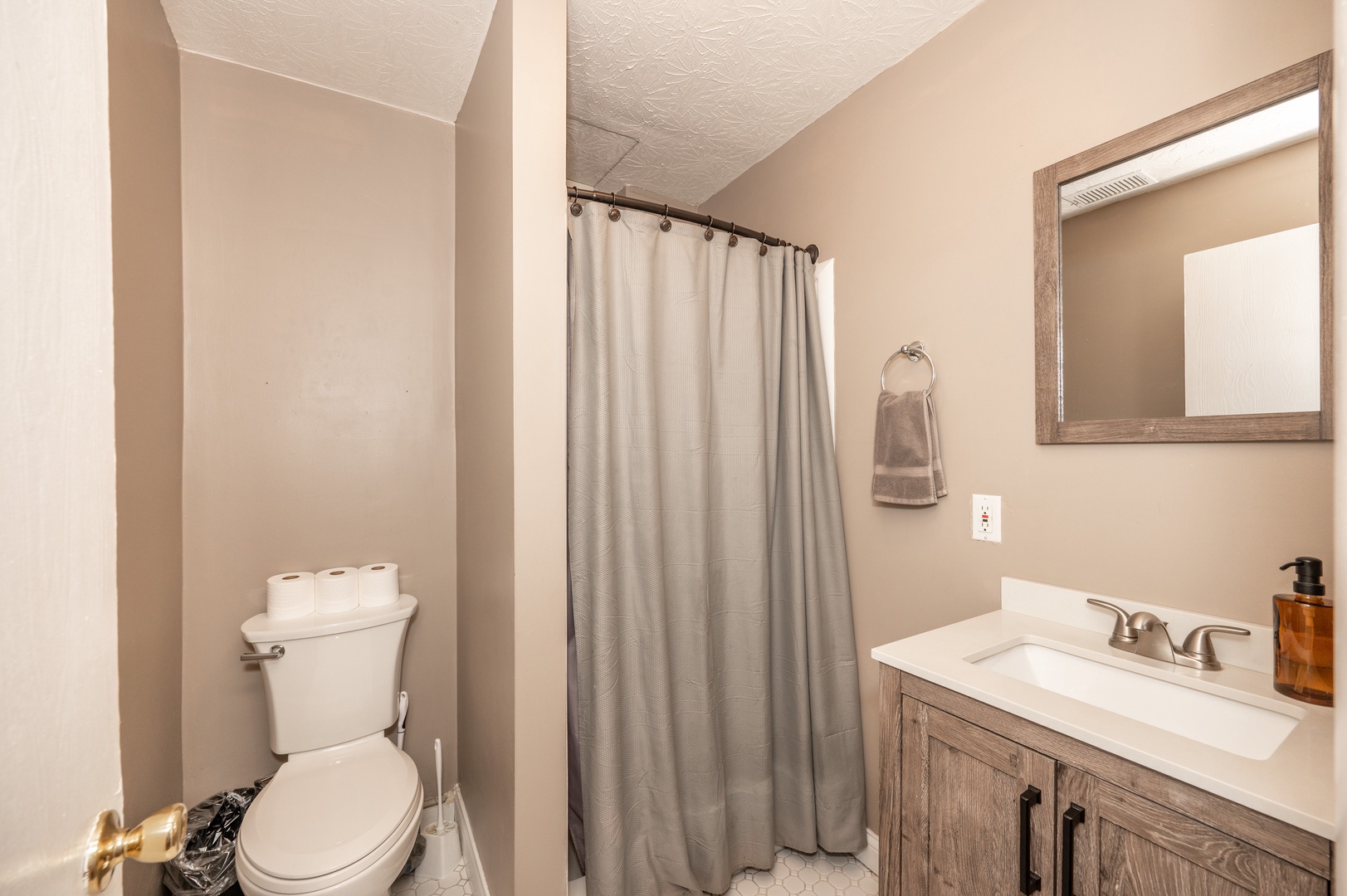 The bathroom is nicely tucked away & offers a walk-in shower