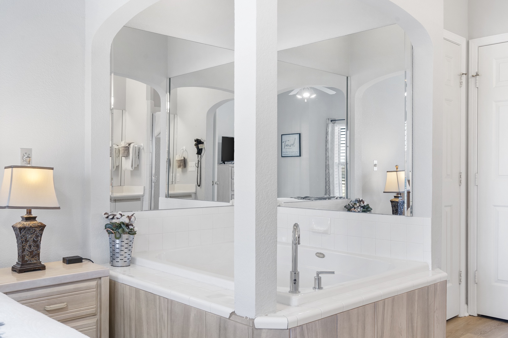 The king ensuite offers a double vanity, shower, & luxurious soaking tub