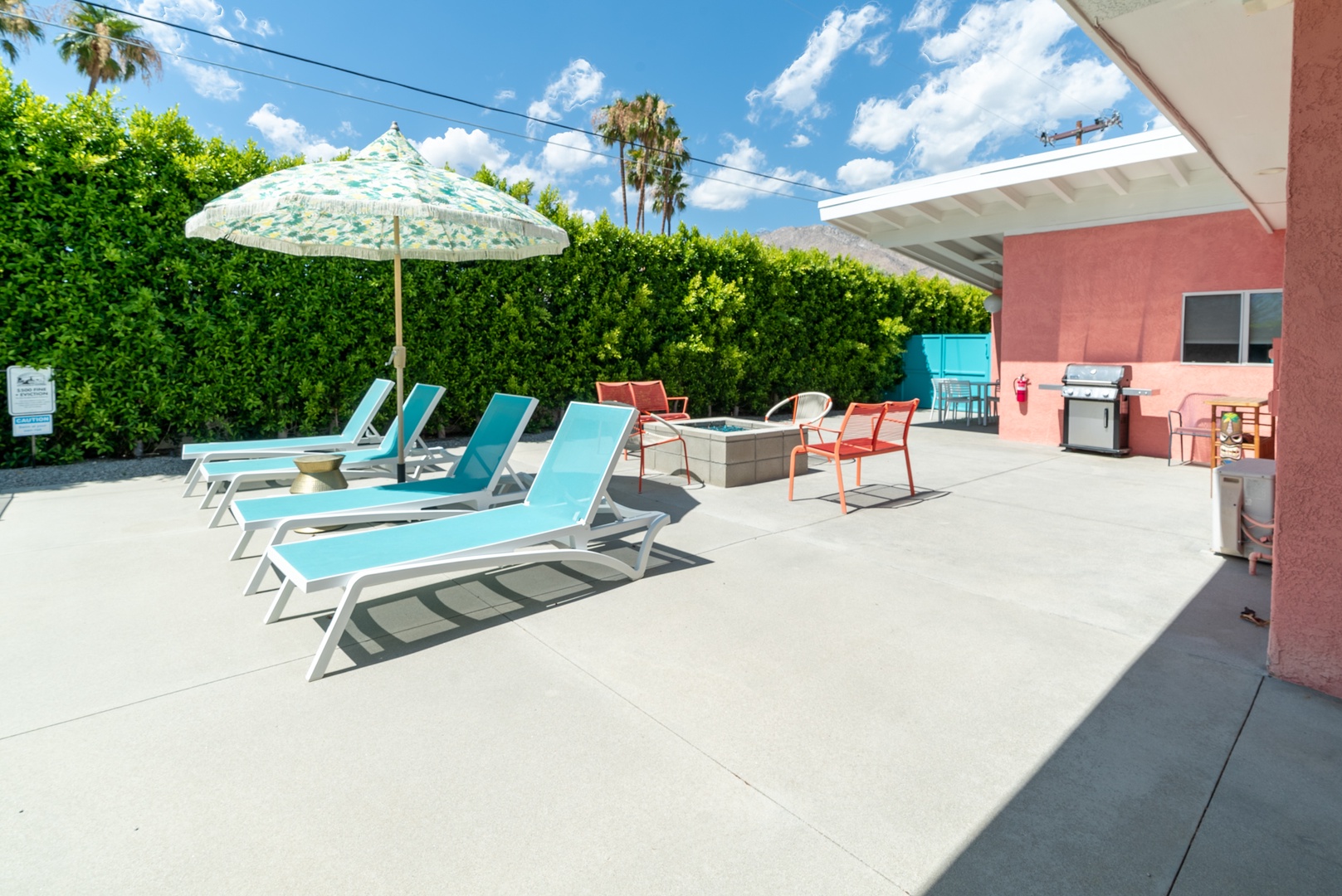 Spacious backyard with an abundance of seating, photo op wall, private pool, and hot tub