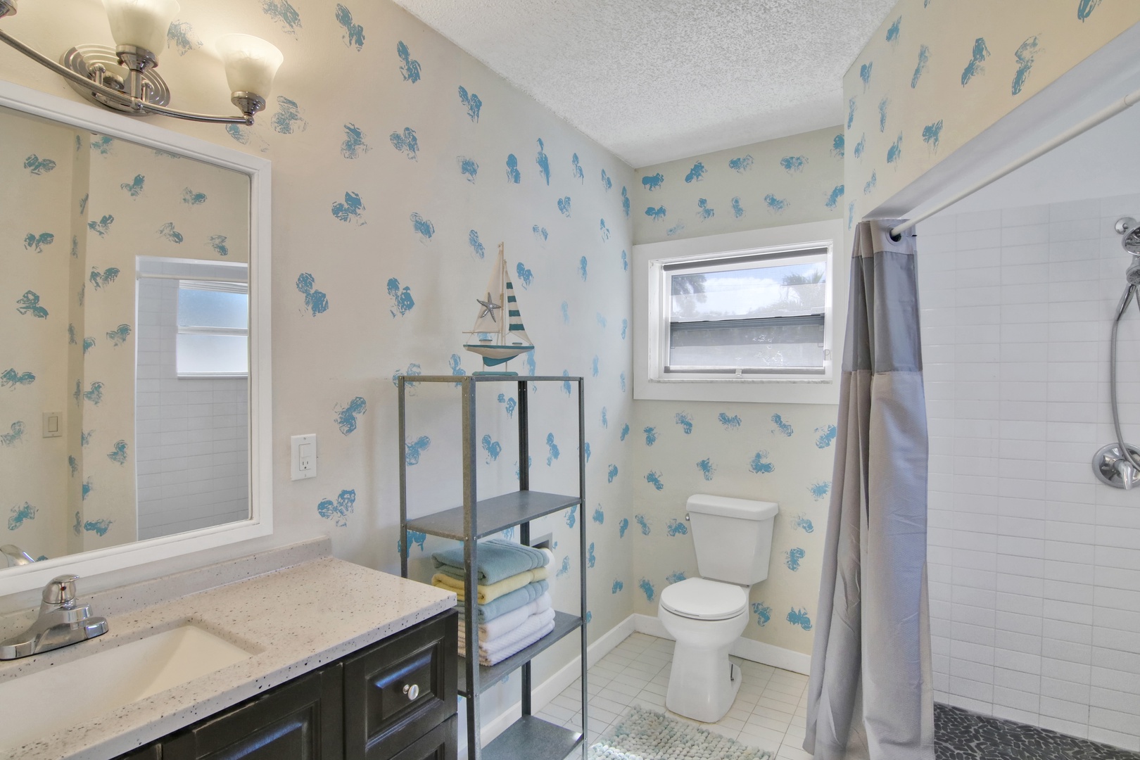 Unit 2: The final full bathroom offers a large vanity & walk-in shower