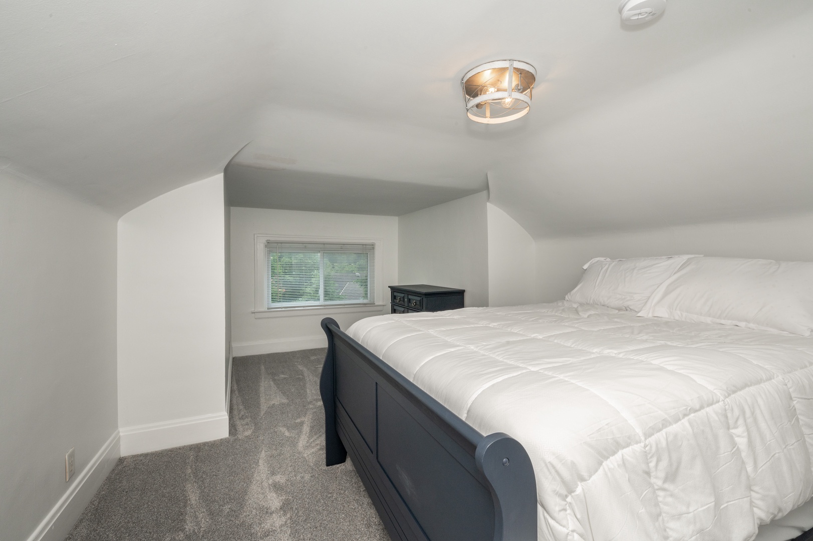 The final spacious bedroom includes a queen bed & dresser