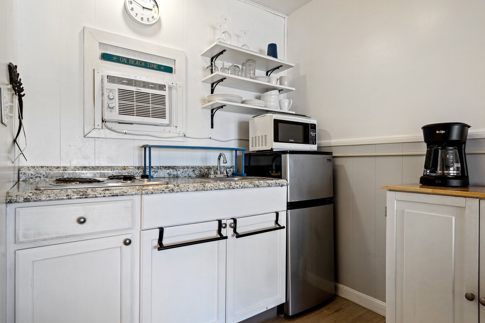 The cozy kitchenette offers ample storage & homey amenities