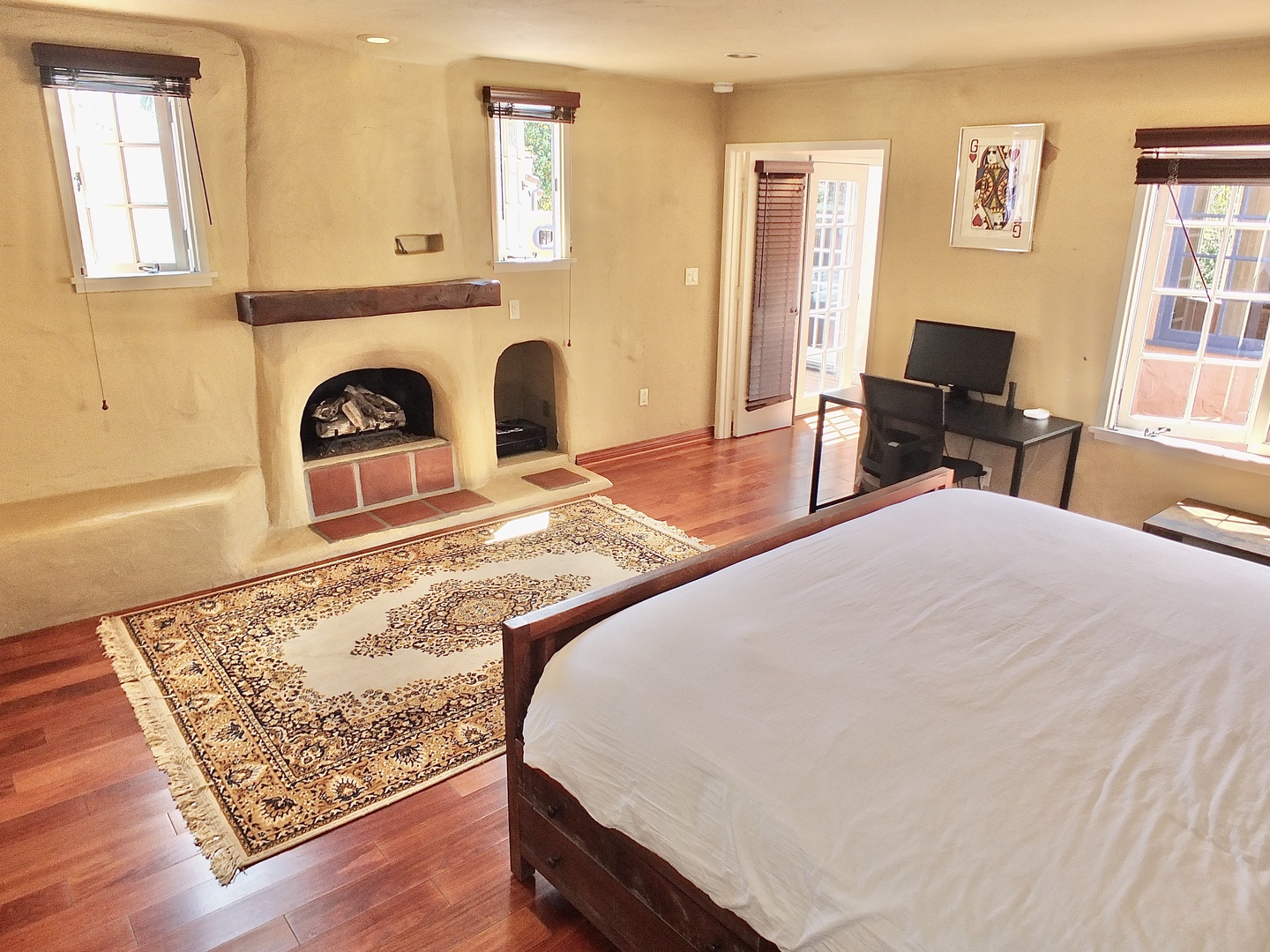 The spacious 2nd floor bedroom offers a king bed, deck access, & private en suite