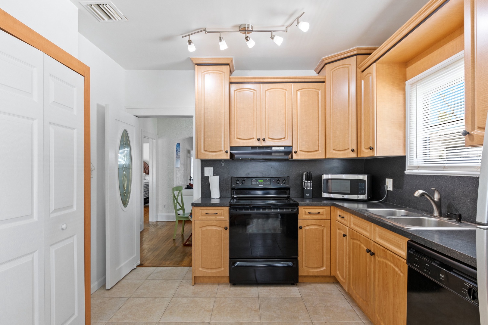 The warm, inviting kitchen offers ample space & all the comforts of home