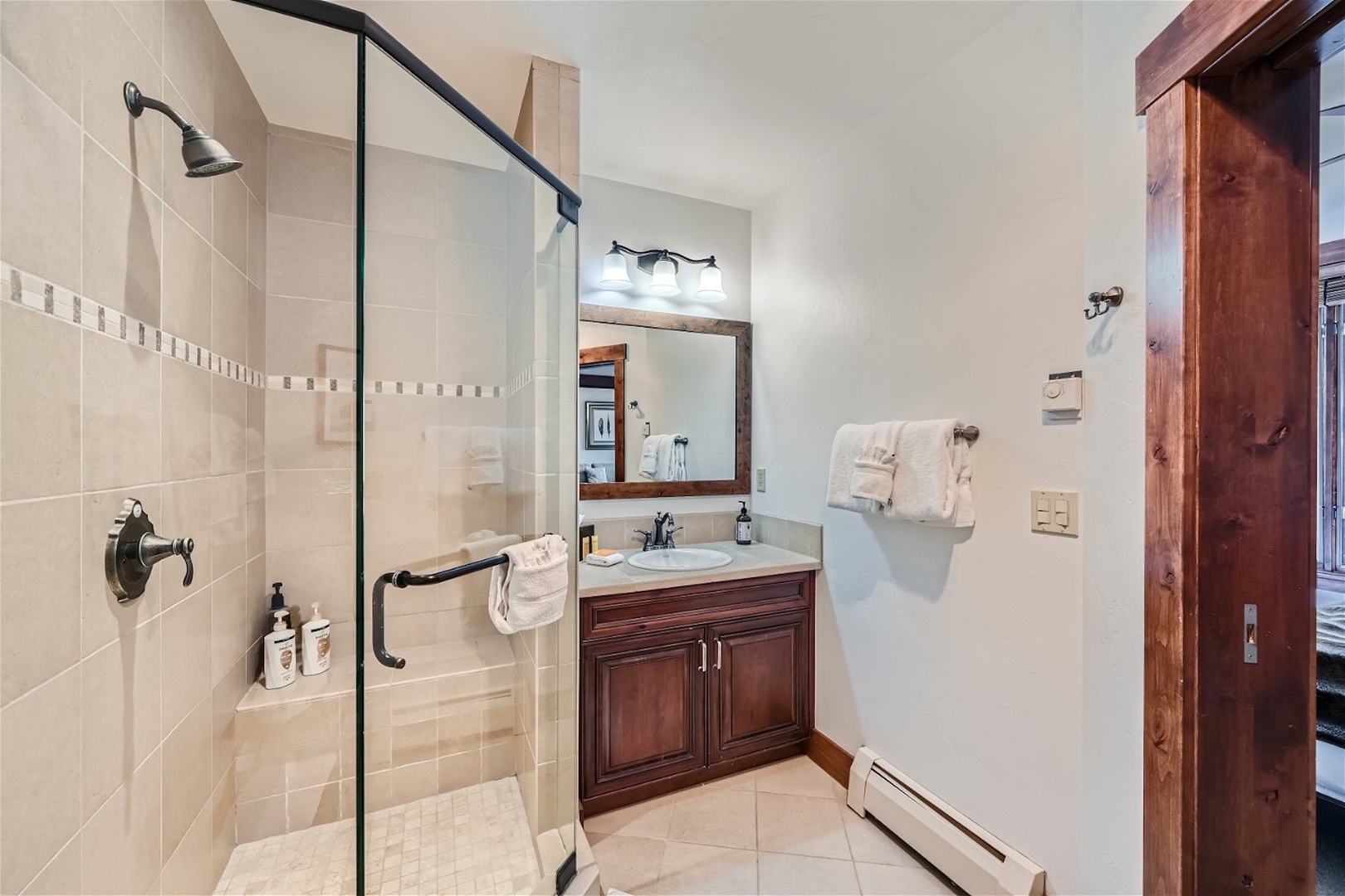 A single vanity & glass shower await in this ensuite bathroom